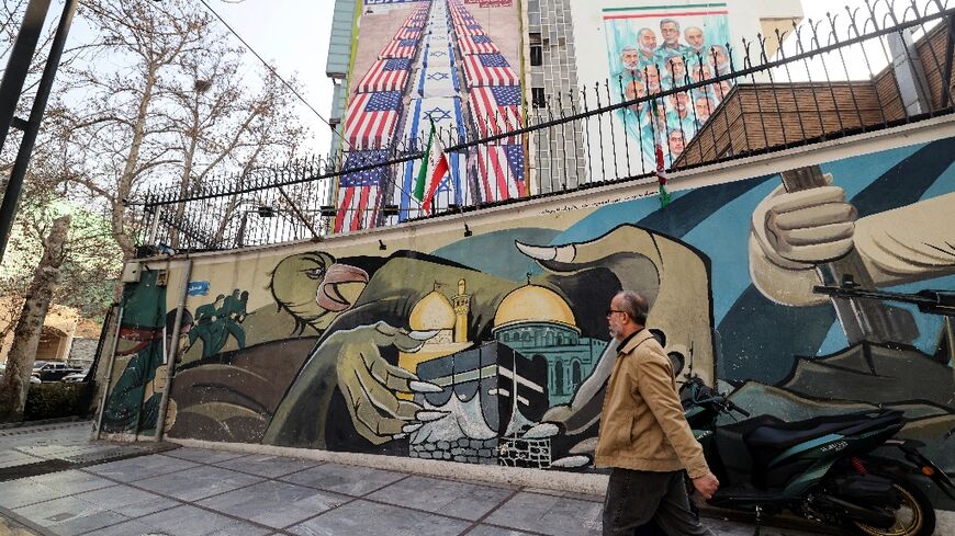 Anti-US and anti-Israel banners hang on a building in Palestine Square in Tehran 