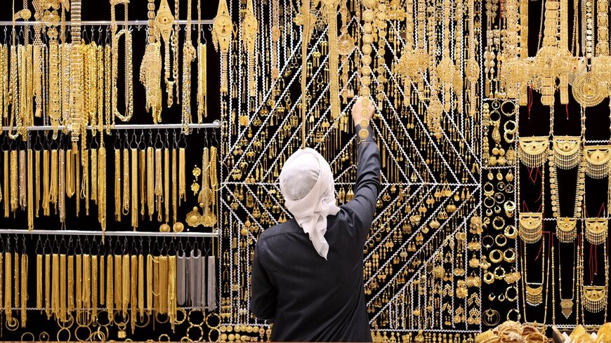 A salesman arranges gold jewelry at Dubai Gold Souk, on Nov. 25, 2020, in Dubai, United Arab Emirates.