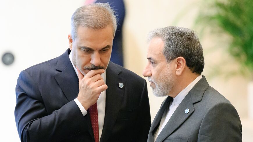 Iranian Foreign Minister Abbas Araghchi (R) speaks with Turkish Foreign Minister Hakan Fidan (L) during the 51st session of the Council of Foreign Ministers of the Organization of Islamic Cooperation in Istanbul, on June 21, 2025.
