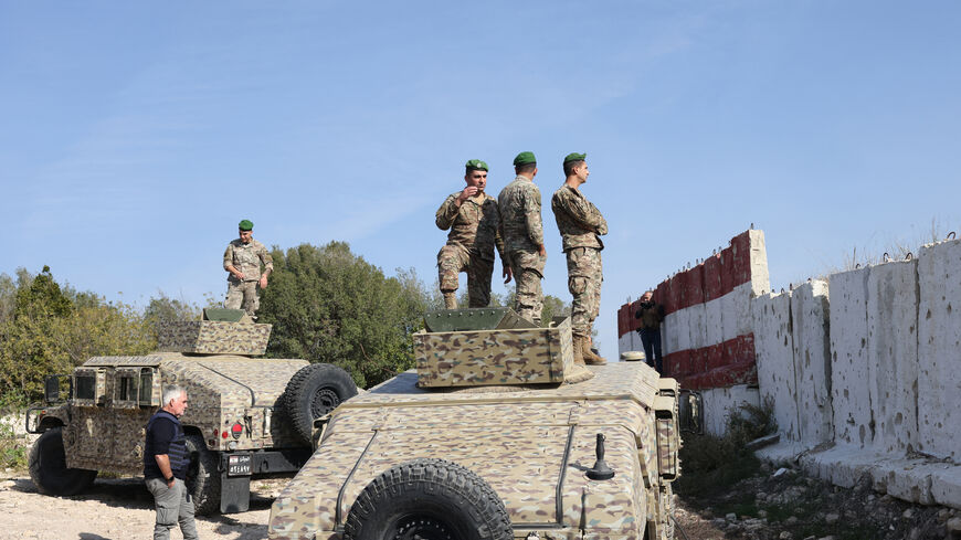 This photograph taken during a press tour organized by the Lebanese army shows Lebanese soldiers standing atop military vehicles in Alma Al-Shaab, near the border with Israel in southern Lebanon, on Nov. 28, 2025. 