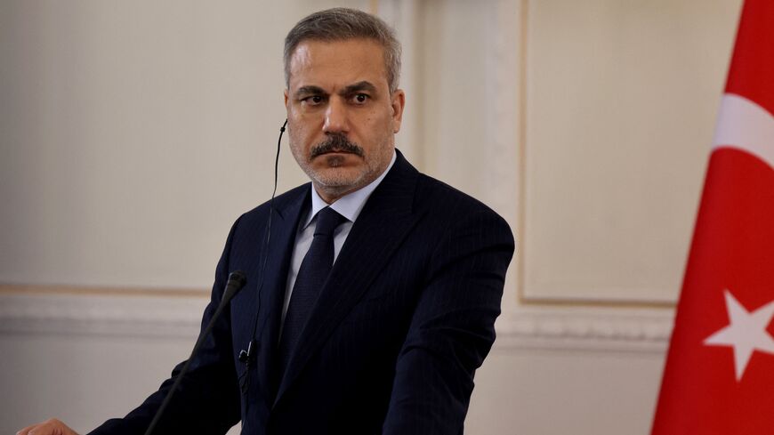 Turkey's Foreign Minister Hakan Fidan listens to Iran's foreign minister during a joint press conference, in Tehran on Nov. 30, 2025. 