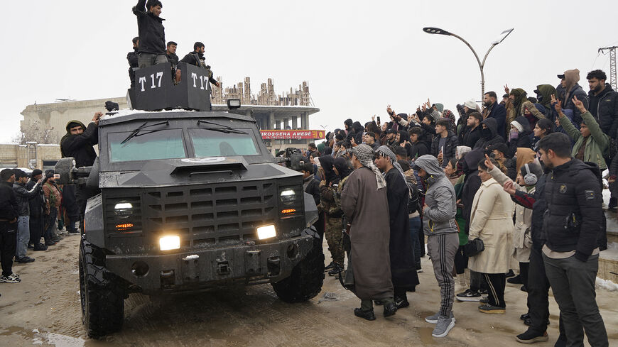 Members of Kurdish-led Syrian Democratic Forces (SDF) arrive at the Kurdish-held city of Ain al-Arab, also known as Kobane on January 23, 2026, after they withdrew from the Al-Aqtan prison in the Raqqa province of Syria. 