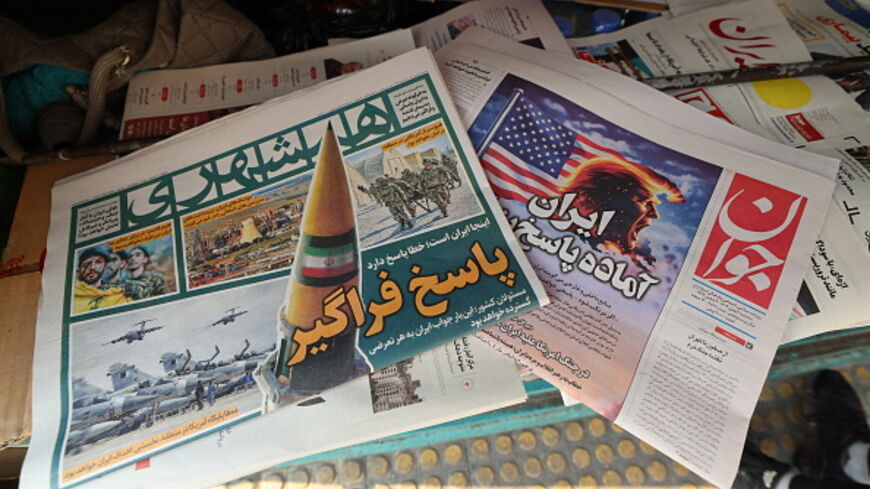 A photograph shows newspapers, one of them (R) with a headline in Persian reading "Iran is ready for a big response", at a kiosk in Tehran on January 27, 2026. (ATTA KENARE / AFP via Getty Images)