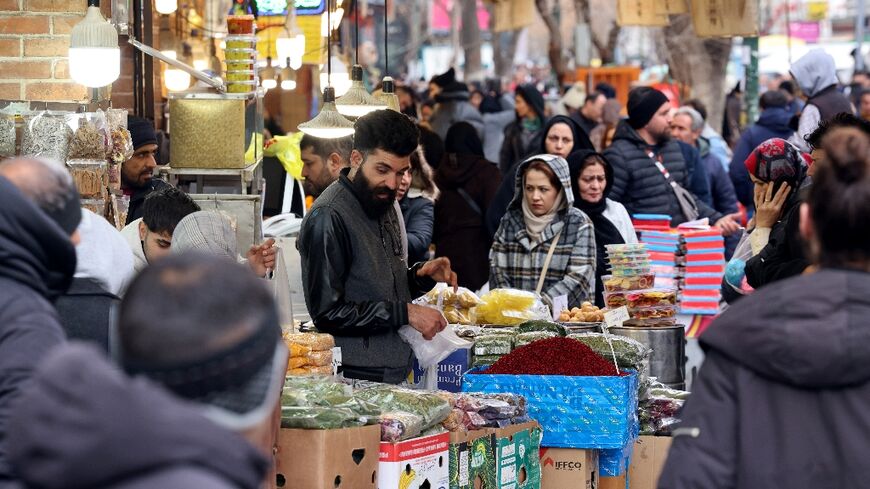 Iranians shop for food at the Grand Bazaar in the capital Tehran
