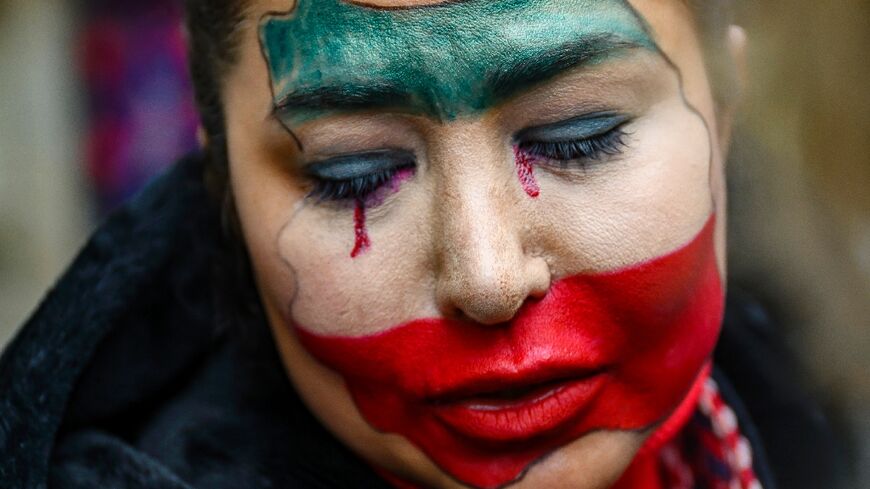Demonstrators gathered under steady rain outside Iran's consulate in Istanbul