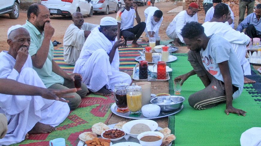 Sudanese people gather to break their fast on the first day of Ramadan