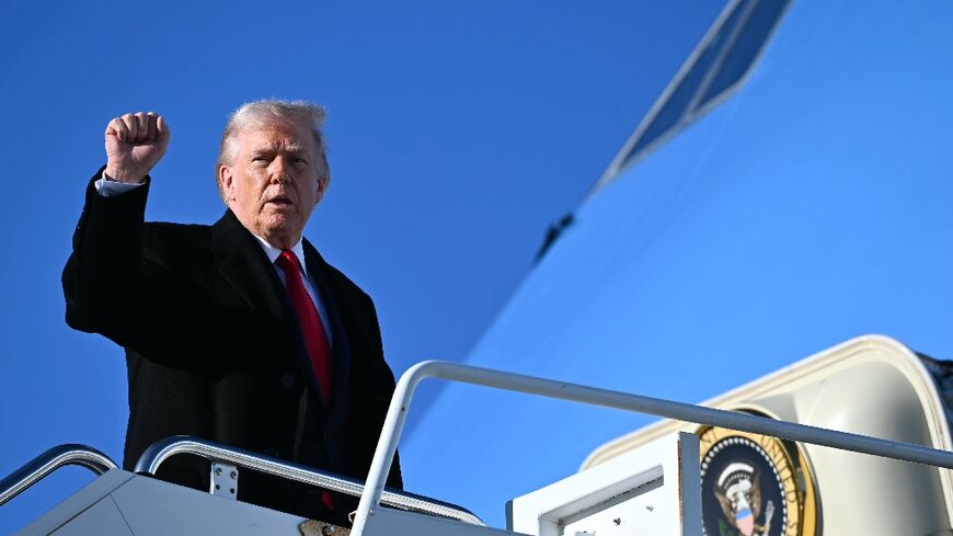 US President Donald Trump gestures as he boards Air Force One at Fort Bragg, North Carolina