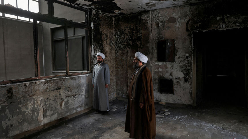 FILE PHOTO: Iranian clerics stand in the Islamic seminary that was burned during Iran's protests, in Tehran, Iran, January 21, 2026. Majid Asgaripour/WANA (West Asia News Agency) via REUTERS/File Photo
