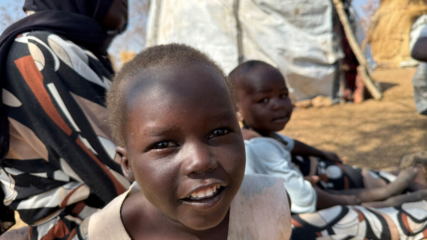 A boy reacts as he sits with his family, displaced from Kadugli, at Embal Camp in Engpung County, Sudan, January 30, 2026. Karl Schembri/Norweigan Refugee Council/Handout via REUTERS    THIS IMAGE HAS BEEN SUPPLIED BY A THIRD PARTY.