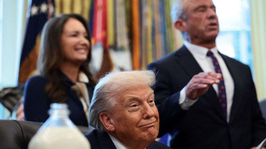 U.S. President Donald Trump listens as U.S. Health and Human Services (HHS) Secretary Robert F. Kennedy Jr. speaks during the signing ceremony for the Whole Milk for Healthy Kids Act in the Oval Office at the White House in Washington, D.C., U.S., January 14, 2026. REUTERS/Evelyn Hockstein