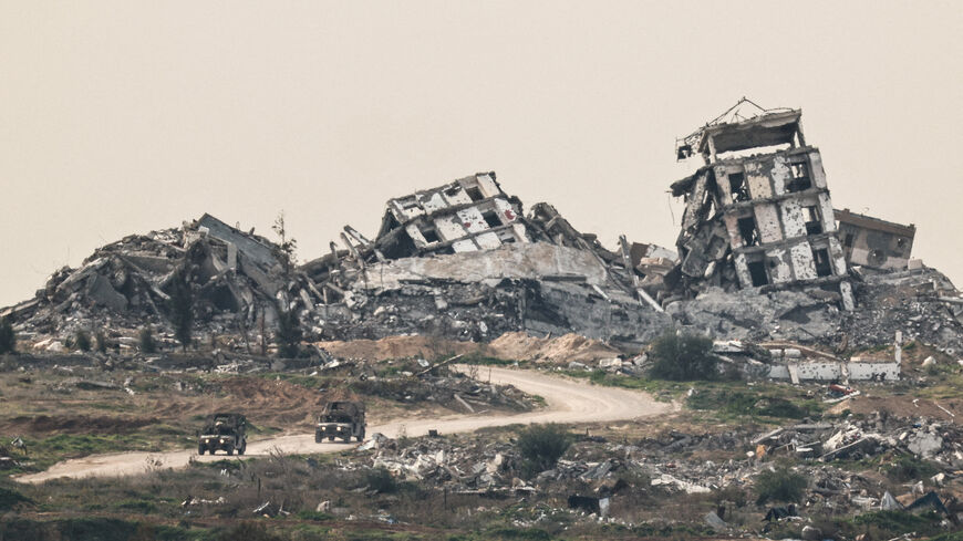 FILE PHOTO: Israeli military vehicles drive past destruction in Gaza, as seen from the Israeli side of the Israel-Gaza border in southern Israel, January 21, 2026. REUTERS/Amir Cohen/File Photo