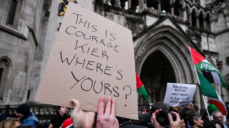 A protester holds a sign with a message against British Prime Minister Keir Starmer outside the High Court, after judges ruled the British government’s decision to designate pro‑Palestinian group Palestine Action as a terrorist organisation unlawful, in London, Britain, February 13, 2026. REUTERS/Jaimi Joy