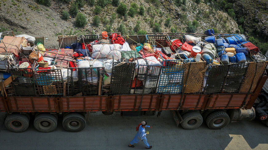 A man walks past a truck loaded with belongings of Afghan nationals, as they head back to Afghanistan after Pakistan started to deport documented Afghan refugees, near Torkham border crossing between Pakistan and Afghanistan, September 1, 2025. REUTERS/Fayaz Aziz