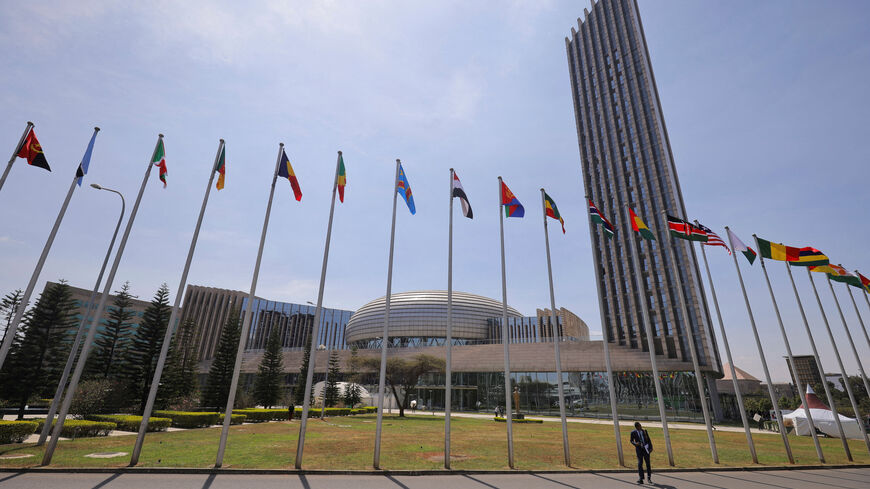 FILE PHOTO: A delegate walks next to African Union (AU) member states flags ahead of the 38th Ordinary Session of the Heads of State and Government of the African Union at the African Union Commission (AUC) headquarters in Addis Ababa, Ethiopia, February 14, 2025. REUTERS/ Tiksa Negeri/File Photo
