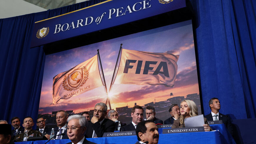 A screen displays an image of FIFA and Board of Peace flags, during the inaugural Board of Peace meeting at the U.S. Institute of Peace in Washington, D.C., U.S., February 19, 2026. REUTERS/Kevin Lamarque