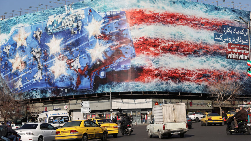 People walk past an anti-U.S. billboard on a street in Tehran, Iran, February 17, 2026. Majid Asgaripour/WANA (West Asia News Agency) via REUTERS