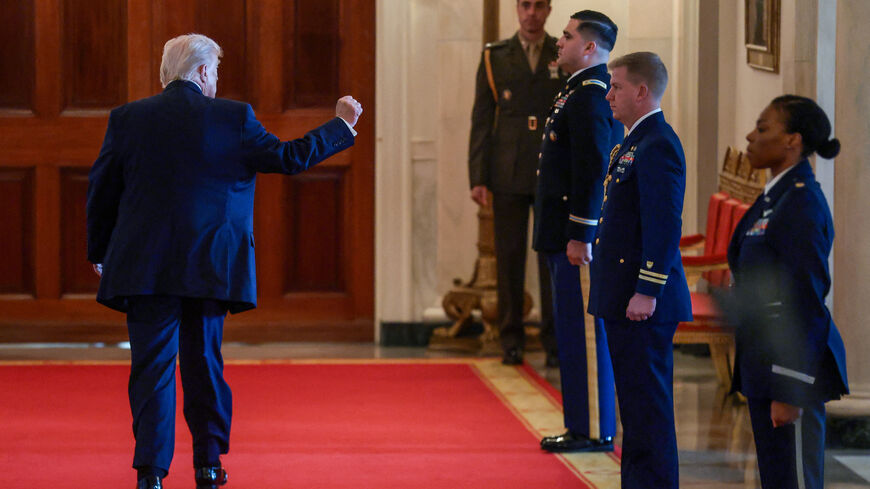 U.S. President Donald Trump raises his fist as he leaves at the end of an event to honor "Angel Families" who have lost family members to crimes committed by people in the country illegally, at the White House in Washington, D.C., U.S., February 23, 2026. REUTERS/Evelyn Hockstein
