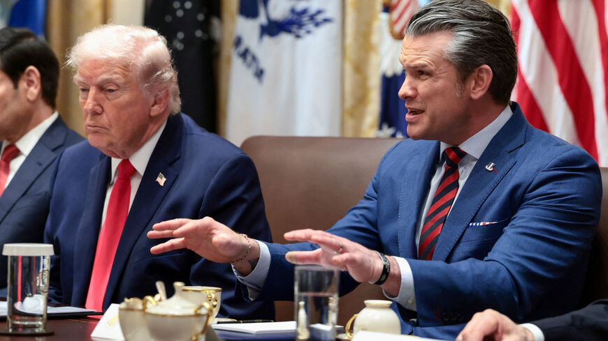 FILE PHOTO: U.S. Defense Secretary Pete Hegseth speaks next to President Donald Trump during a cabinet meeting at the White House in Washington, D.C., U.S., January 29, 2026. REUTERS/Evelyn Hockstein/File Photo