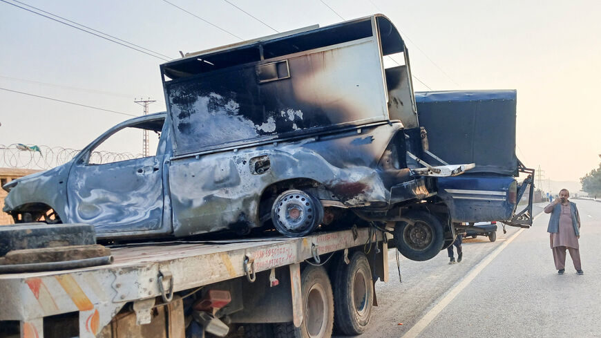 A man uses his mobile to film the damaged police vehicles, loaded on a truck, after a terrorist attack in Kohat, in Khyber Pakhtunkhwa province, Pakistan February 24, 2026. REUTERS/Syed Basit