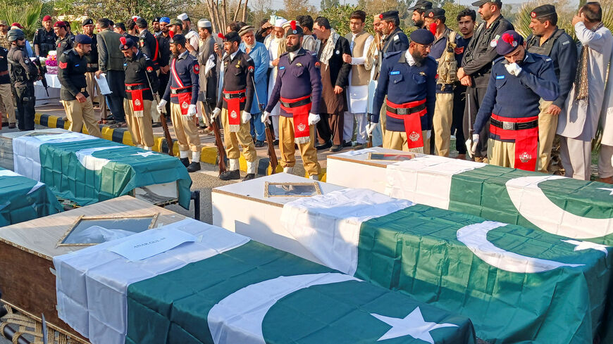 Police officers and residents gather beside Pakistani flag-draped coffins of police officers who were killed following a terrorist attack on a police vehicle, during a funeral in Kohat, in Khyber Pakhtunkhwa province, Pakistan, February 24, 2026. REUTERS/Syed Basit