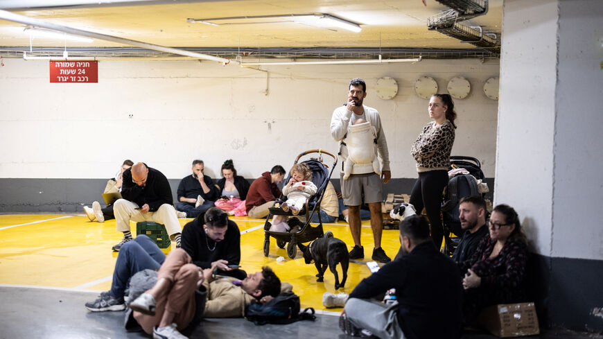 Israelis take shelter in an underground parking lot after missiles were launched towards Israel from Iran following strikes by Israel and the U.S. on Iran, in Tel Aviv, Israel, February 28, 2026. REUTERS/Itai Ron