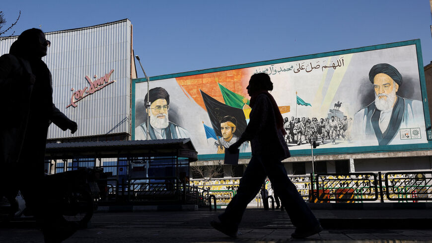 People walk near a mural featuring images of Iran's Supreme Leader Ayatollah Ali Khamenei and the leader of Iran's 1979 Islamic Revolution Ayatollah Ruhollah Khomeini, on a street in Tehran, Iran, February 26, 2026. Majid Asgaripour/WANA (West Asia News Agency) via REUTERS