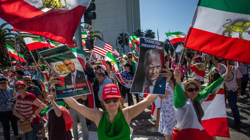 A woman holds pictures of Reza Pahlavi - the son of Iran's former Shah - and US President Donald Trump as members of the Iranian community celebrate in Los Angeles