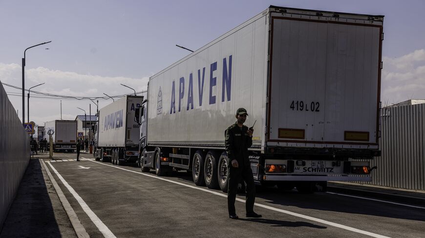 Several trucks carrying humanitarian aid cross the border between Armenia and Turkey at the village of Margara, Armenia, on March 21, 2025. 