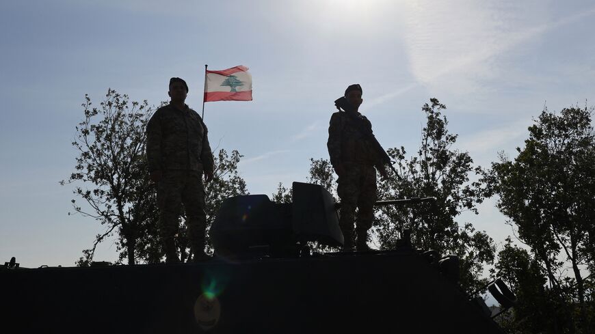 Lebanese soldiers standing atop a military vehicle in Alma Al-Shaab, near the border with Israel in southern Lebanon, on Nov. 28, 2025. 