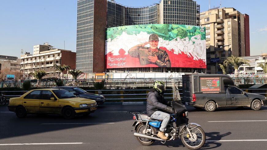 Iranians ride their motorbike past a huge banner of former Iran Islamic Revolutionary Guard Corps (IRGC) Quds Force commander Qasem Soleimani ahead of the sixth anniversary of his assassination, in Tehran, Dec. 31, 2025. 