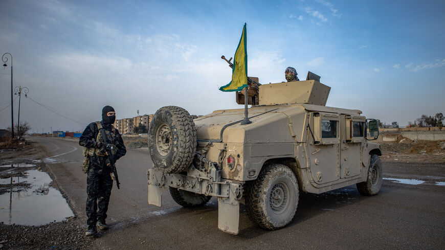 Members of People's Defense Units (YPG) stand guard as Syrian government internal security personnel enter the northeastern city of Hasakeh, a Kurdish stronghold, on Feb. 2, 2026.  