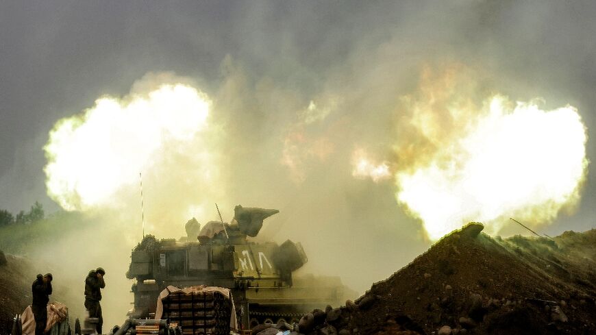 An Israeli self-propelled howitzer artillery gun fires rounds towards southern Lebanon