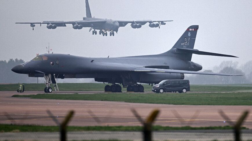 A US Air Force Boeing B-52 Stratofortress bomber jet lands on the runway, beyond a USAF Rockwell B-1 Lancer bomber jet, at RAF Fairford in south west England on March 9, 2026.