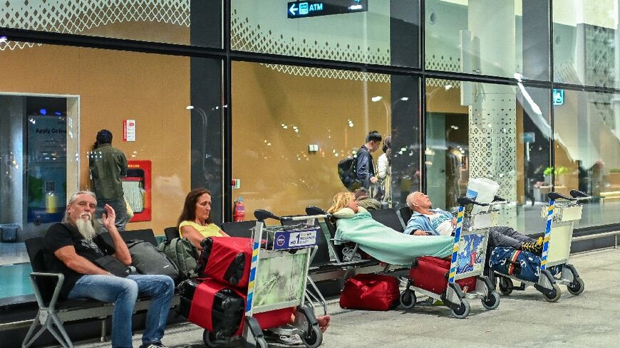 Stranded passengers wait at the Velana International Airport in Male on March 1, 2026 after the cancellation of flights destined for the Middle East