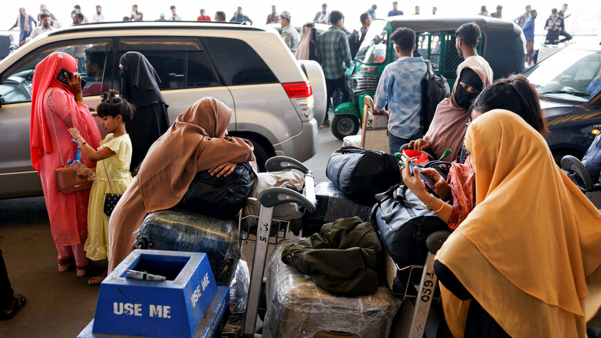 Stranded passengers wait at Hazrat Shahjalal International Airport after flights to Dubai and Bahrain were cancelled after Iranian strikes, following strikes on Iran launched by the United States and Israel, in Dhaka, Bangladesh, March 1, 2026. REUTERS/Mohammad Ponir Hossain