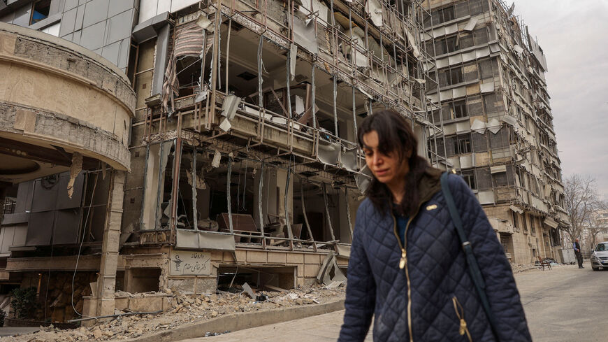 A woman walks on the street following an Israeli and U.S. strike on Gandhi Hotel Hospital, amid the U.S.-Israel conflict with Iran, in Tehran, Iran, March 2, 2026. Majid Asgaripour/WANA (West Asia News Agency) via REUTERS