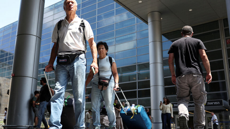 Israeli nationals walk at Ben Gurion International airport as they arrive on the first rescue flight from abroad, after U.S. President Donald Trump announced a ceasefire between Israel and Iran, in Tel Aviv, Israel, June 24, 2025. REUTERS/Violeta Santos Moura