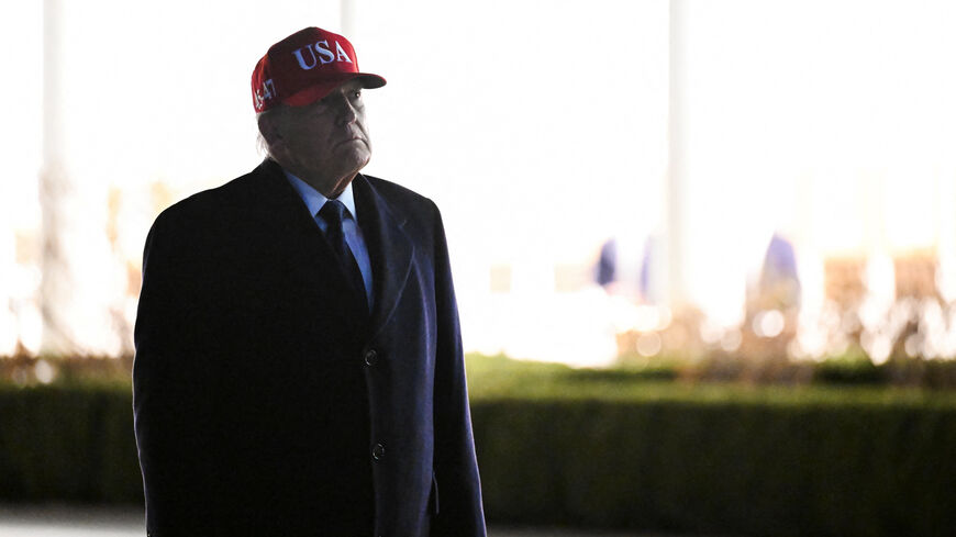 U.S. President Donald Trump looks at statues in the Rose Garden while returning to the White House, after Israel and the U.S. launched strikes on Iran, in Washington, D.C., U.S., March 1, 2026. REUTERS/Annabelle Gordon