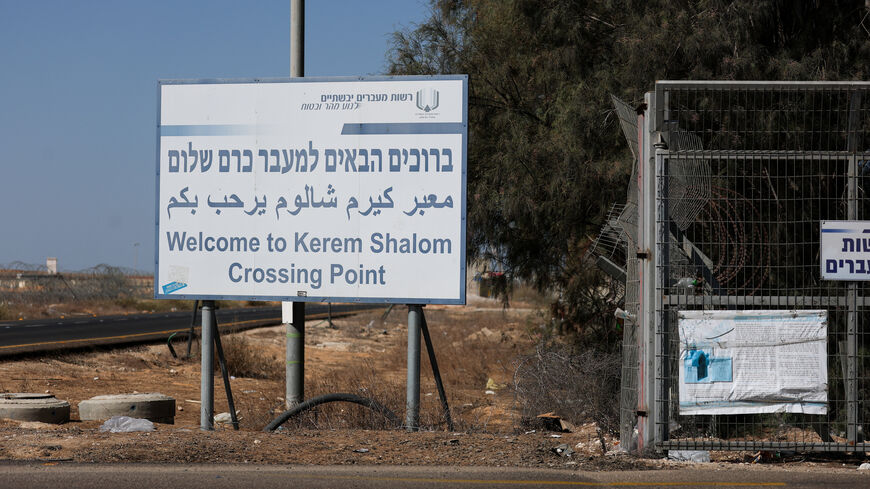 A view shows a sign as trucks carrying aid (not pictured) wait at the Israeli side of the Kerem Shalom border crossing to southern Gaza in southern Israel, October 20, 2025. REUTERS/Hannah McKay/File Photo
