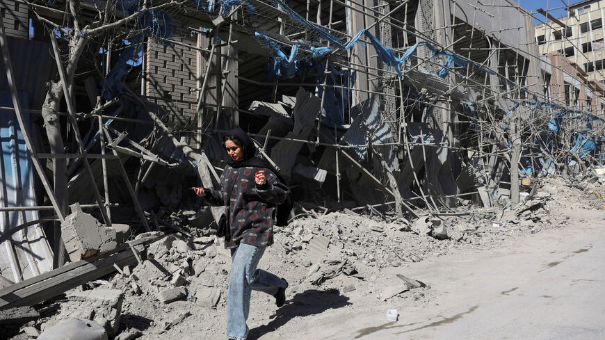 A woman walks on the street following an Israeli and U.S. strike on a police station, amid the U.S.-Israeli conflict with Iran, in Tehran, Iran, March 3, 2026. Majid Asgaripour/WANA (West Asia News Agency) via REUTERS