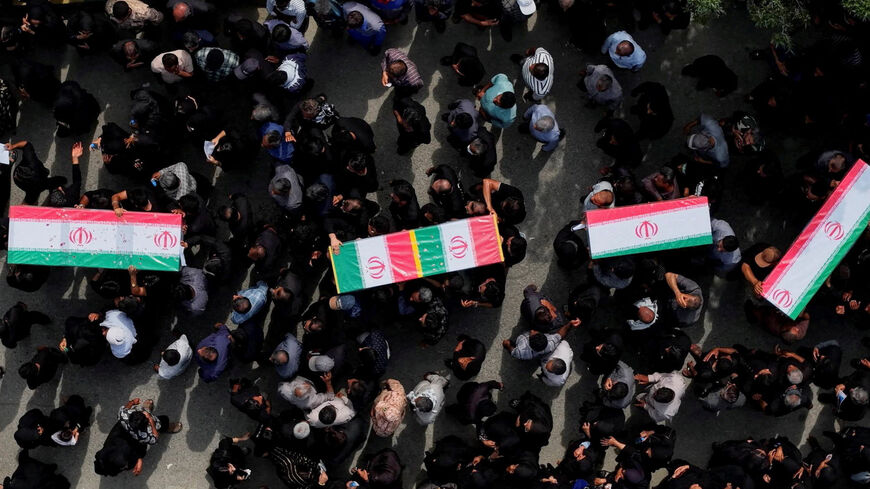 People carry coffins as they attend the funeral of the victims following an Israeli strike on a school, amid the U.S.-Israeli conflict with Iran, in Minab, Iran, March 3, 2026. Amirhossein Khorgooei/ISNA/WANA (West Asia News Agency) via REUTERS