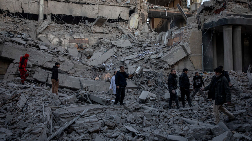 People stand in rubble at the site of an Israel and U.S. strike on a police station in Tehran, Iran, March 3, 2026. Majid Khahi/ISNA/WANA (West Asia News Agency) via REUTERS