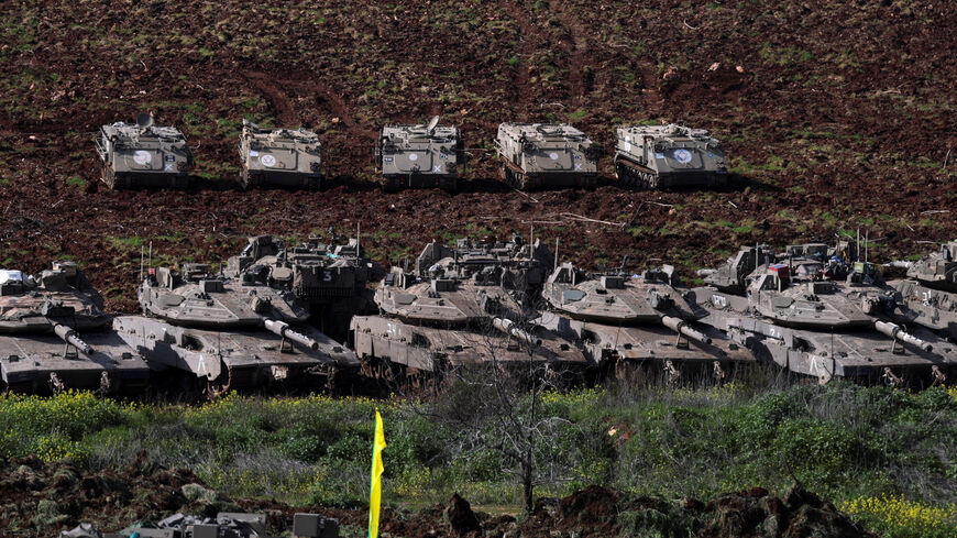 Israeli military vehicles sit on the Israeli side of the border with Lebanon, amid escalation between Hezbollah and Israel, amid the U.S.-Israeli conflict with Iran, in northern Israel, March 6, 2026. REUTERS/Ammar Awad