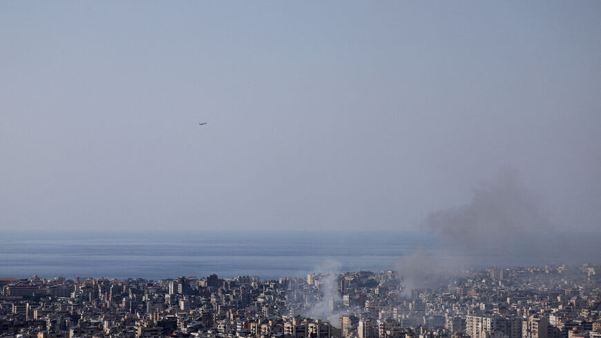 FILE PHOTO: Smoke rises after an Israeli airstrike as a plane takes off from Rafik Hariri Airport, following an escalation between Hezbollah and Israel amid the U.S.-Israeli conflict with Iran, in Beirut, Lebanon March 3, 2026. REUTERS/Khalil Ashawi/File Photo