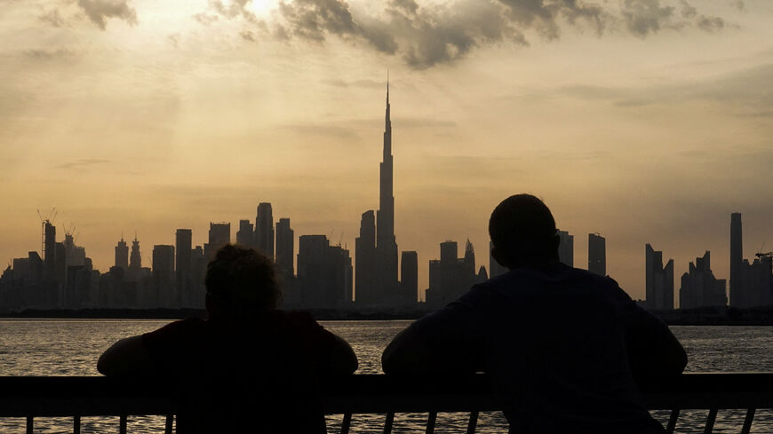 People way the sunset over Dubai, with a general view of the Dubai skyline, including Burj Khalifa, center, amid the U.S.-Israel conflict with Iran, in United Arab Emirates, March 6, 2026. REUTERS/Amr Alfiky