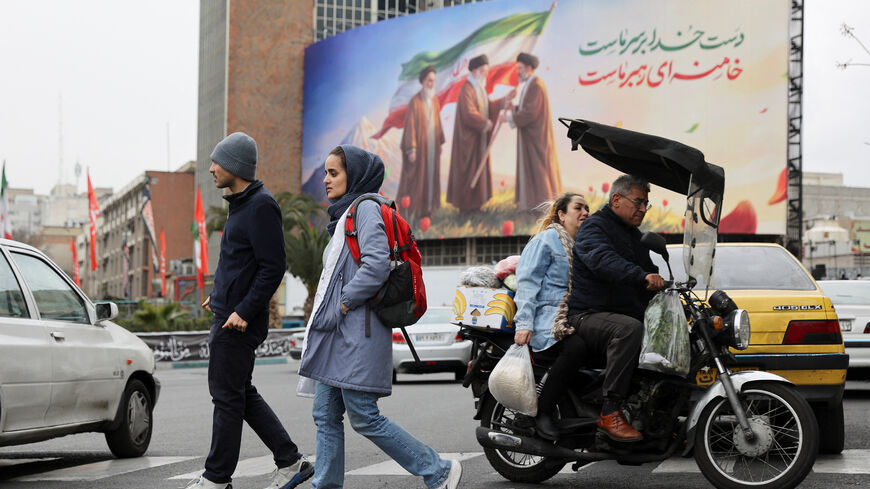 People walk on a street with a banner of Iran's new supreme leader Mojtaba Khamenei with late supreme leader Ayatollah Ali Khamenei and late supreme leader Ayatollah Ruhollah Khomeini in the background, amid the U.S.-Israeli conflict with Iran, in Tehran, Iran, March 10, 2026. Majid Asgaripour/WANA (West Asia News Agency) via REUTERS