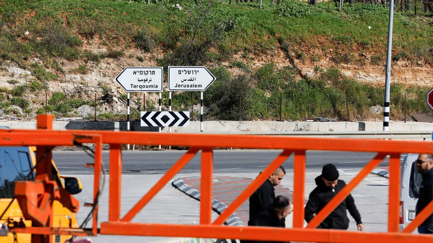 Taxi driavers wait near an Israeli gate, after Israeli forces sealed entrances to cities and villages amid heightened restrictions during the conflict with Iran, near Hebron in the Israeli-occupied West Bank, March 1, 2026. REUTERS/Mussa Qawasma