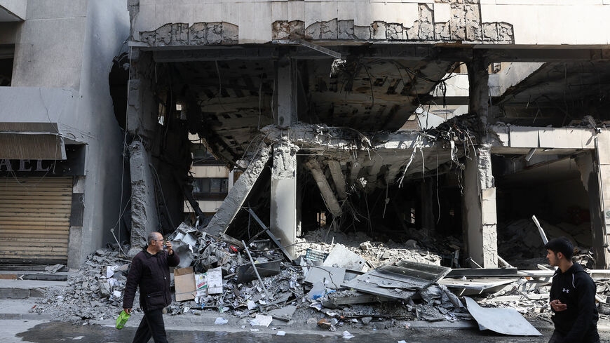 A man walks by a damaged building, in the aftermath of yesterday's Israeli strikes, following an escalation between Hezbollah and Israel amid the U.S.-Israeli conflict with Iran, in the Zuqaq al-Blat district in central Beirut, Lebanon, March 13, 2026. REUTERS/Mohamed Azakir