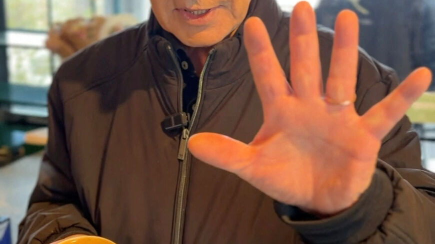 Israeli Prime Minister Benjamin Netanyahu shows his hand as he speaks at a cafe, amid the U.S.-Israeli conflict with Iran, in Jerusalem, March 15, 2026, in this screen grab taken from a handout video. Benjamin Netanyahu via Telegram/Handout via REU