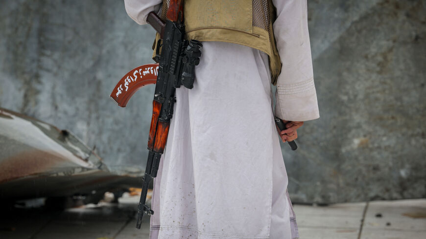 A Taliban security personnel guards the site of a drug rehabilitation centre destroyed in what the Taliban said was a Pakistani air strike in Kabul, Afghanistan, March 18, 2026. REUTERS/Sayed Hassib